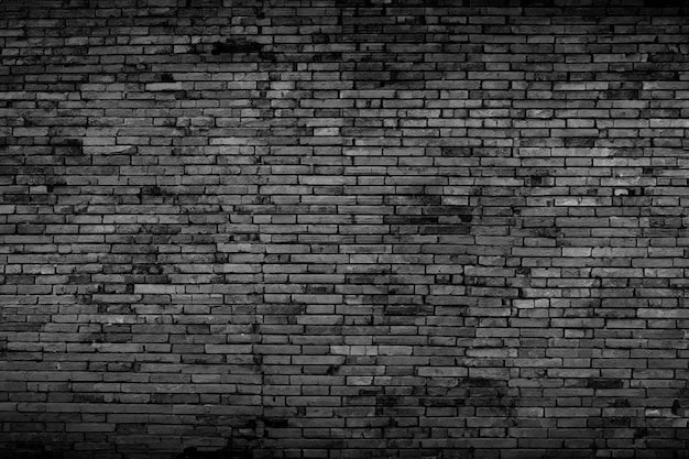 Black brick walls that are not plastered background and texture The texture of the brick is black Background of empty brick basement wall
