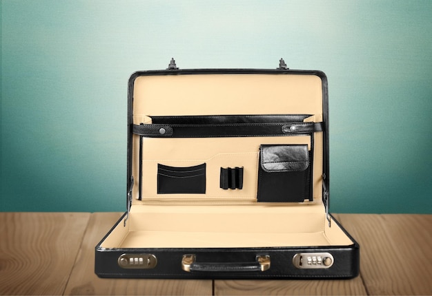 Black briefcase opened on desk