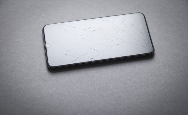 Black broken smartphone. Broken screen