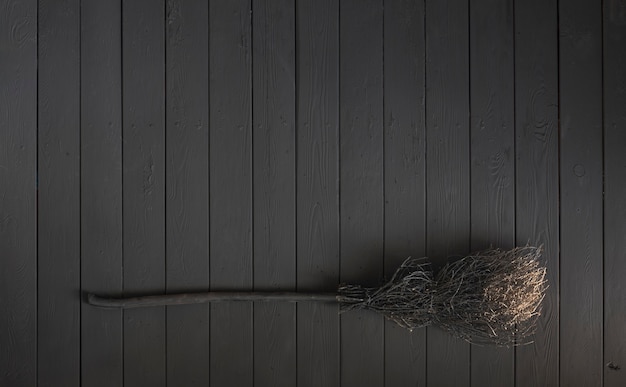 black broom isolated on black background