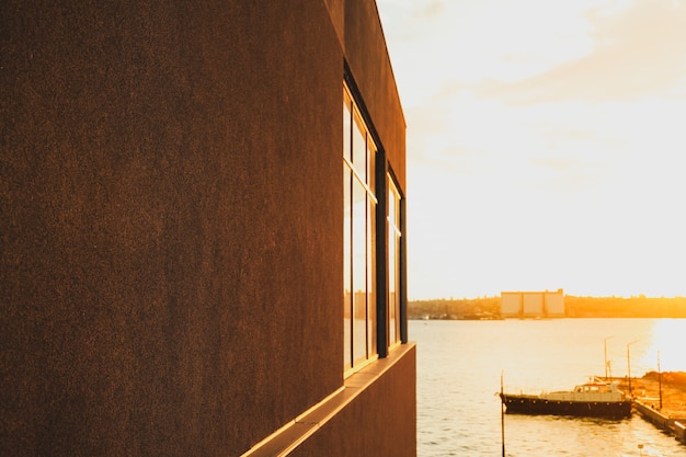 Black building with empty wall near the river