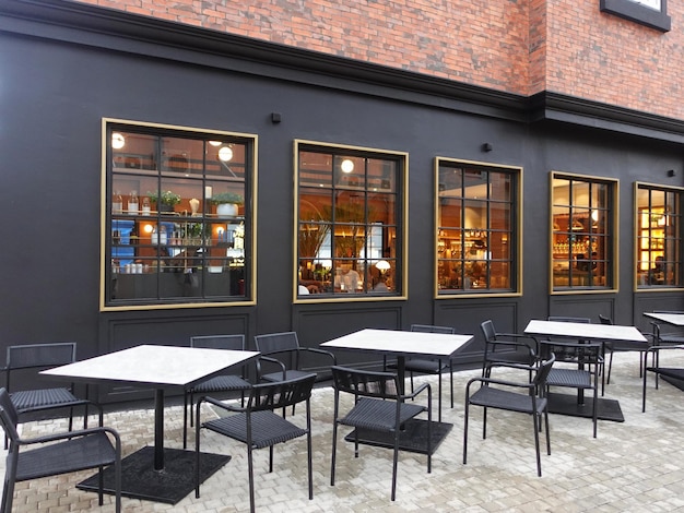 A black building with a large window that says " the word cafe " on it.