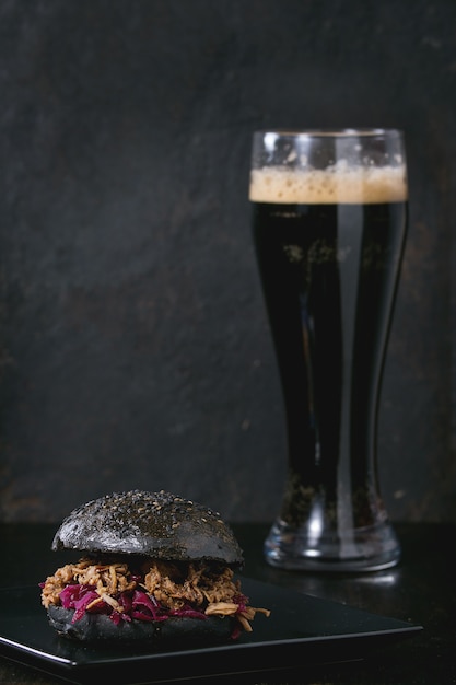 Black burger with dark beer