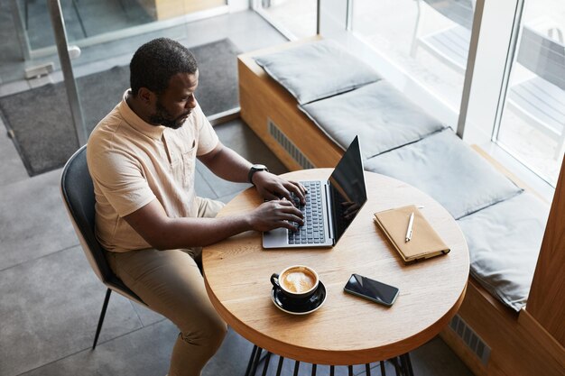 Black Businessman Working in Cafe