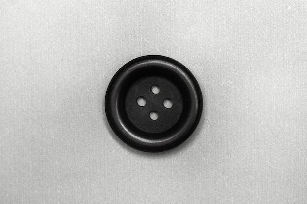 Photo a black button on a gray background in a close up view