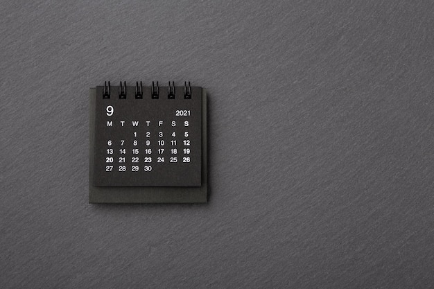 Black calendar on black stone background