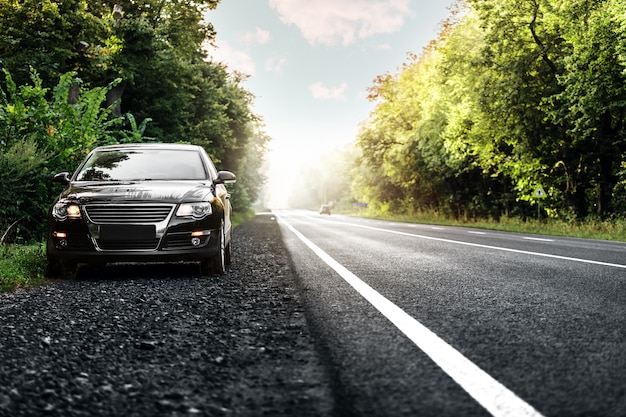 Black car on asphalt road