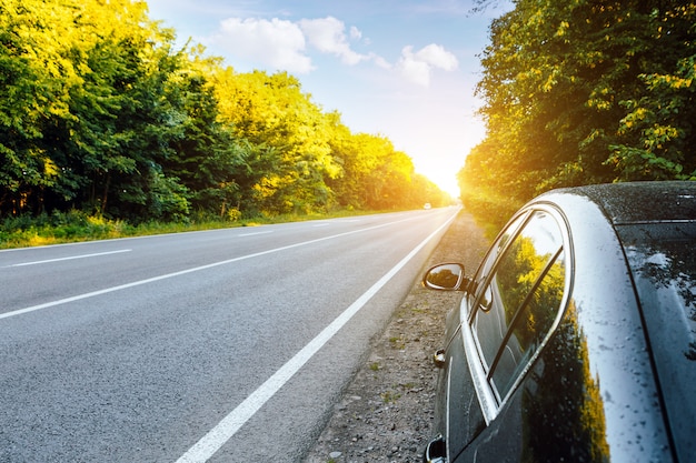 Black car on asphalt road