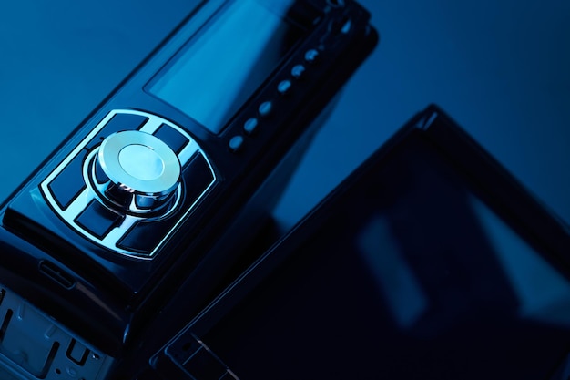 Black car radio tape recorder closeup on black background audio system control panel