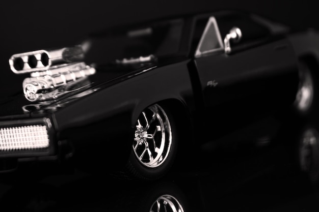 A black car with a chrome rim and a chrome rim.