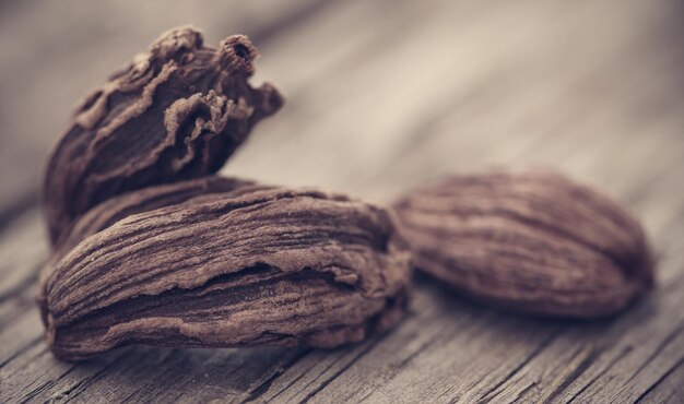 Black cardamom on wooden surface