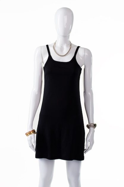 Black casual dress on mannequin. Female mannequin in simple dress. Plain black dress with u-neck. Casual garment for young ladies.