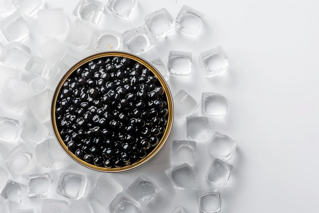 Photo black caviar in a can standing on ice cubes top view isolated on solid white background