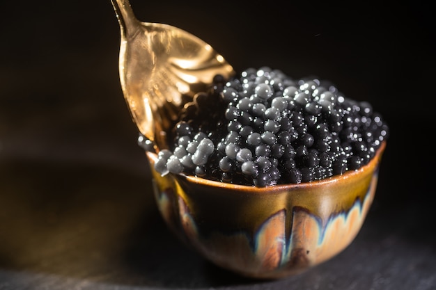 Black caviar and spoon close-up