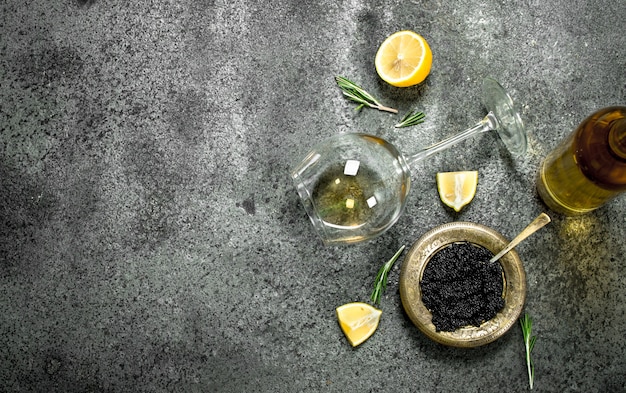 Black caviar with white wine and lemon.