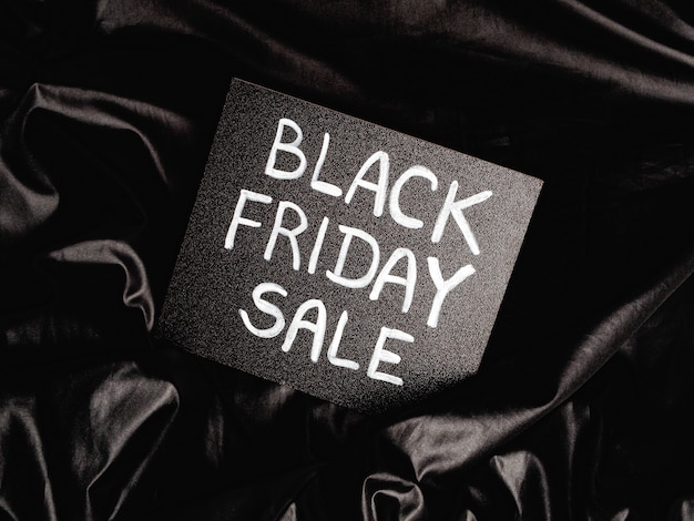 Photo black chalk board with chalk lettering black friday sale on black satin