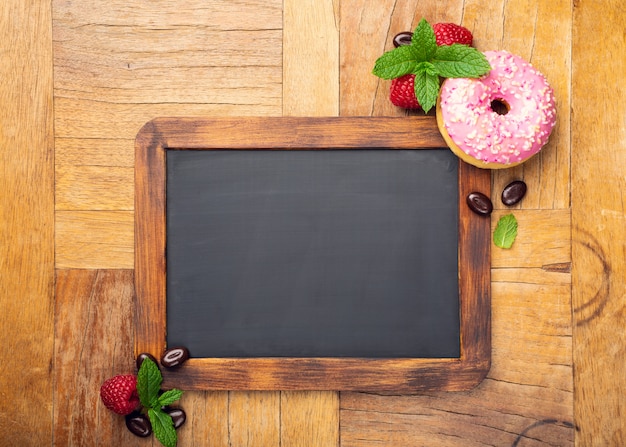 Black chalkboard with pink glazed donut