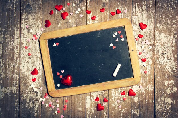 Black chalkboard with small hearts around