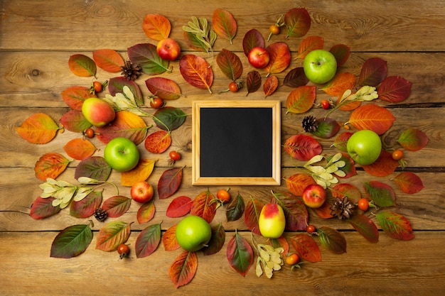 Black chalkboard wooden square frame rustic mockup with fall leaves. Empty blackboard frame mock up for presentation design. Template black felt letter board framing for modern art.