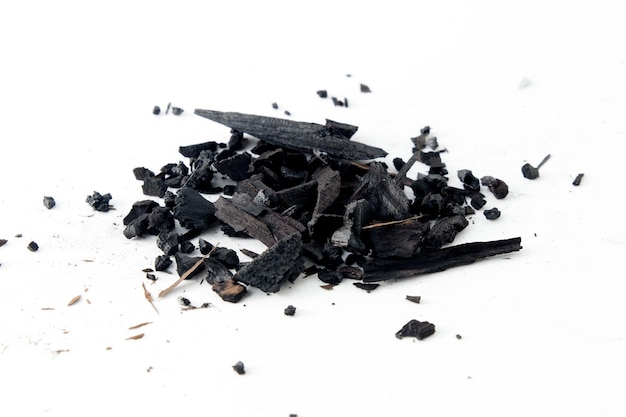 Фото Частицы черного угля, изолированные на белом фоне порошок активированного угля