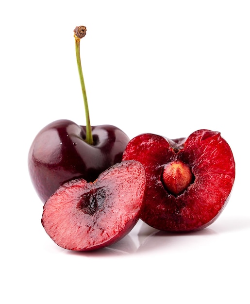 Premium Photo | Black cherry cut in half and isolated on white background,  black republican cherries. juicy fruit with seeds inside.