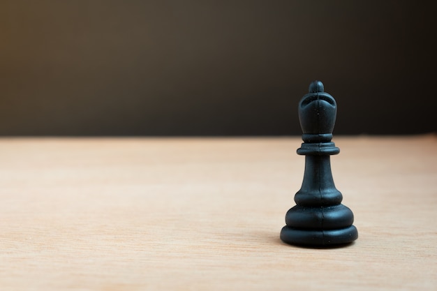 Black chess bishop with black background