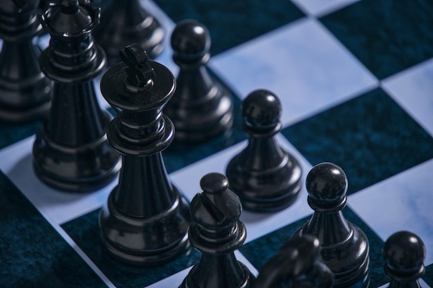 Black chess pieces on a chessboard