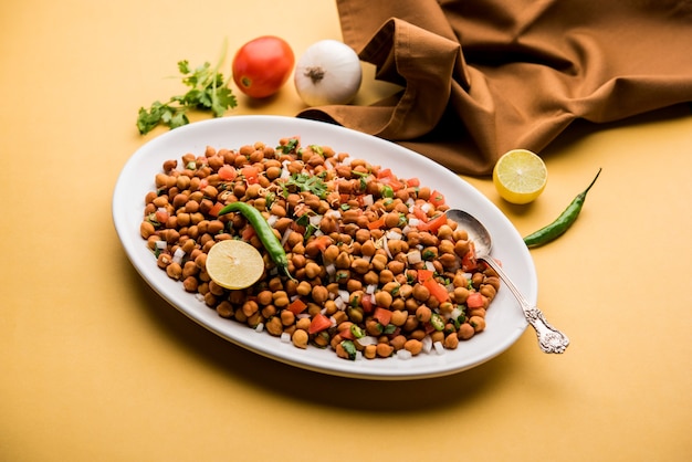 Black Chickpea Chaat or Kala Chana Chat recipe is a popular snack recipe from India, served in a bowl. selective focus