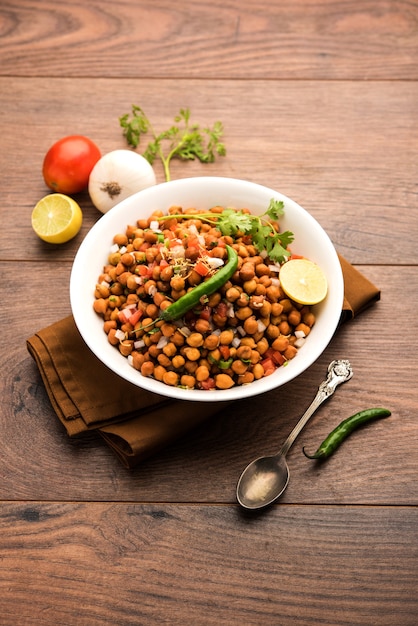 Black Chickpea Chaat or Kala Chana Chat recipe is a popular snack recipe from India, served in a bowl. selective focus