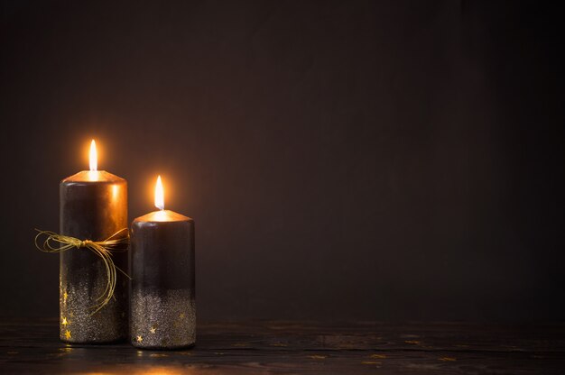 Black Christmas candles on dark background