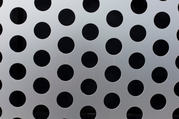 Photo black circles on a metal surface  texture background