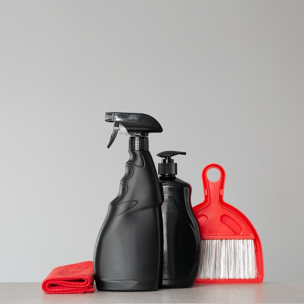 Black cleaning products and red cleaning tools 