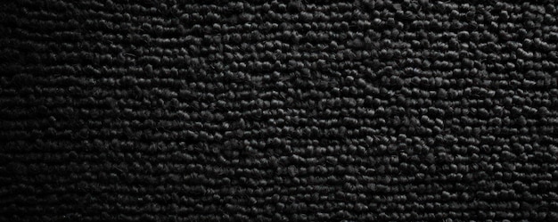 Black closeup of monochrome carpet texture background from above Texture tight weave carpet blank em