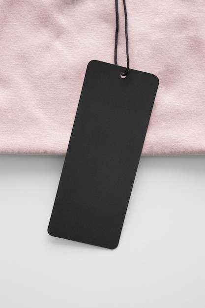 Black clothing tag mockup on a soft pink tshirt