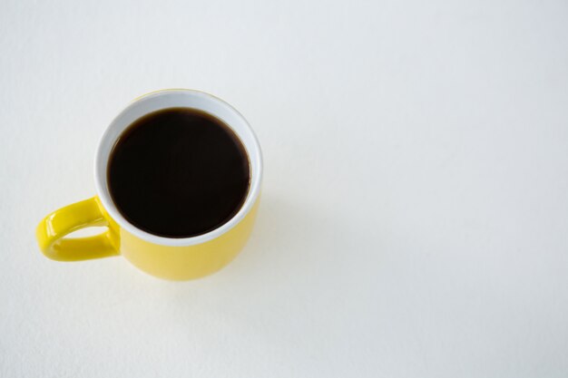 Black coffee served in yellow cup