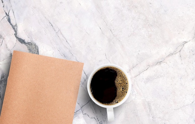 Black coffee in white cup on white marble background