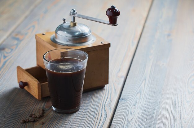 Black coffee with coffee grinder placed