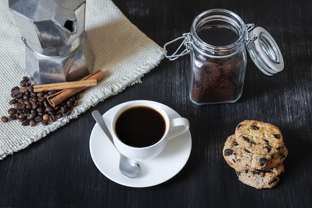 Black coffee with italian mocha pot and cookies