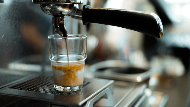 black coffee with milk on a coffee maker