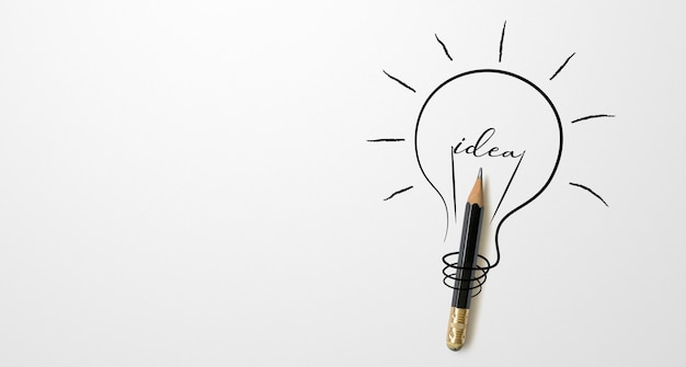 Black colour pencil with outline light bulb drawing and the word idea white background