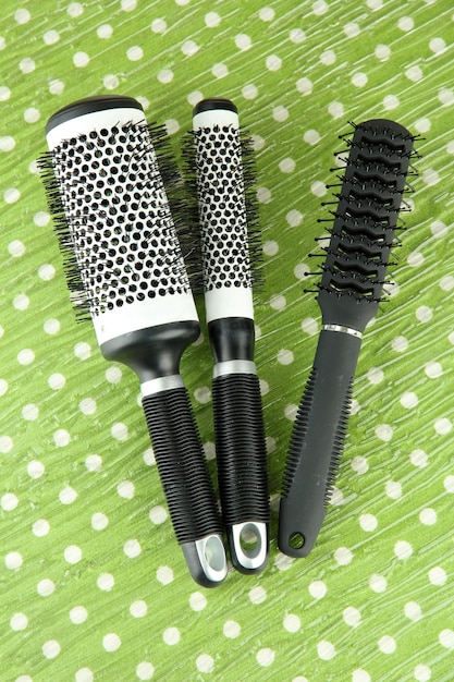 Black combs on color background