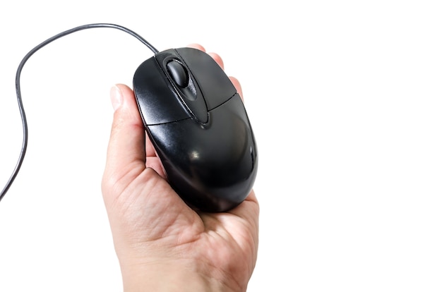 Black computer mouse in female hand on white