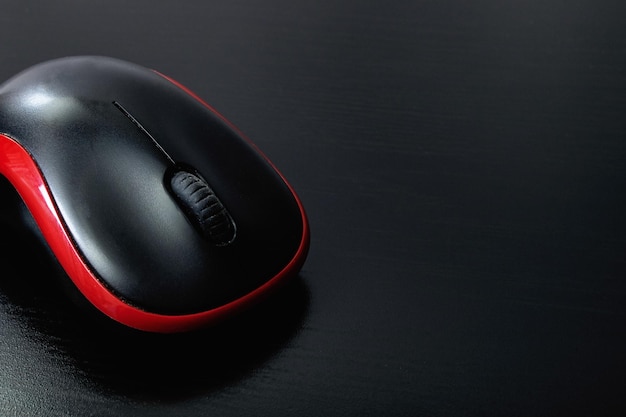 Black computer mouse on a wooden table