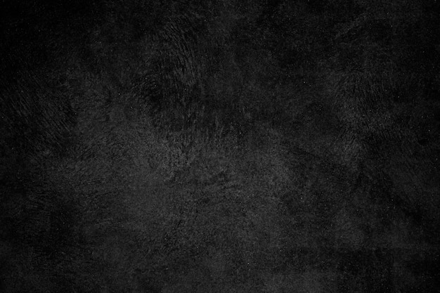 Black concrete plaster wall with rough grunge texture for background