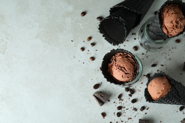 Black cones with ice cream on white textured