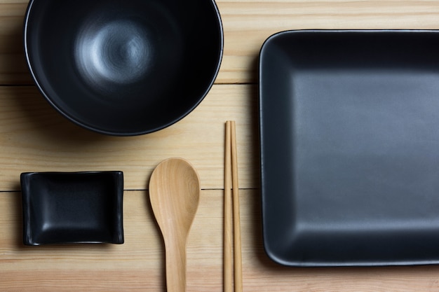 Black container placed on a wooden table.