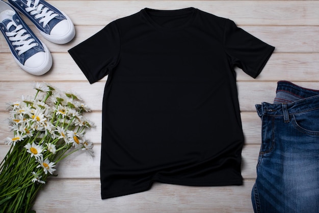 Black cotton tshirt mockup with wild daisy flowers bouquet and\
jeans design t shirt template tee print presentation mock up