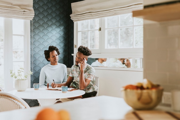 Photo black couple on the phone at home