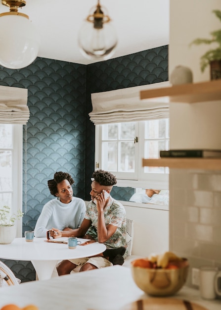 Black couple on the phone at home