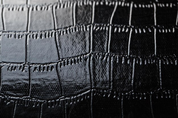 Black crocodile skin texture as background in full screen closeup